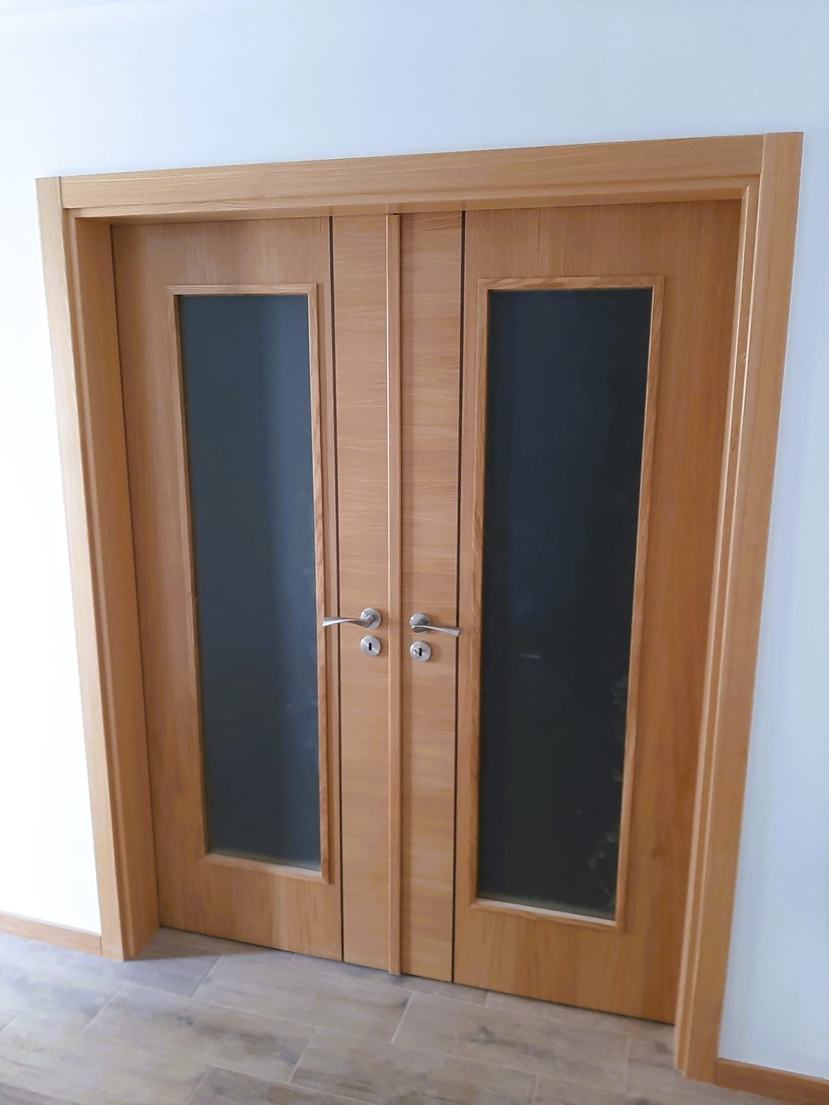 Double oak door with frosted glass and a visible frame